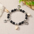 Detail of Bohemian beaded bracelet with silver turtle charms and natural shells - Black