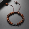 Detail of beaded wooden bracelet for men with metal arrow charm and adjustable cord - Coffee