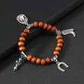 Detail view of western style wood bead bracelet with cowboy hat and boots silver charms - Tan