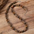 Boho-Choker mit Tigerauge-Steinen, mattierten Perlen und dunklen Kokosnussschalen-Scheiben - Tigerauge