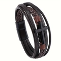 Dettaglio di un bracciale multistrato in pelle intrecciata con croce e chiusura magnetica - caffè