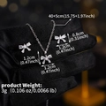 Detail of bow-shaped necklace and earrings set with sparkling cubic zirconia inlay - Silver Bow (NS-J6558S)