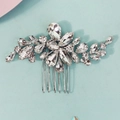 Detailed macro view of sparkling rhinestone flower hair comb with silver finish and metal prongs - Silver