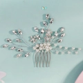 Detailed view of silver bridal hair comb with rhinestones and white pearls on blue background - HS-J7344S