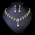 Close-up of bridal jewelry set with crystal teardrop necklace and matching earrings - Necklace And Earrings Set (NS-J6482G) / Gold