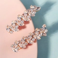 Two gold-finished barrettes featuring sparkling marquise and round crystal clusters - Gold