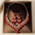 Detailed close-up of wedding jewelry set with red crystals and gold-tone finish - Gold Red Rhinestone Style (NS-J6524GRED)