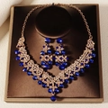 Elegant bridal necklace and earring set with deep blue crystals on a golden alloy base - Gold Blue Rhinestone Style (NS-J6524GBLUE)