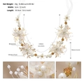 Detail shot of a white floral bridal headband with artificial pearls and rhinestones - Elegant Gold (HS-J6940G)