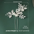 Detailed macro of wedding hair pin with white pearls, metal leaves and crystal beads - Silver (HS-J7180S)