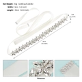Close-up of sparkling rhinestone flower patterns on a white bridal satin sash belt - Silver
