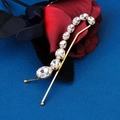 Close-up of golden hair clip with round rhinestones placed on red rose petals - HS-J6772G