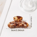 Brown amber hair claw clip with shell texture, 9cm width sizing detail on white background - Brown