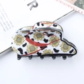 Haarklem met koeienprint en zonnebloemenpatroon met rode kleuraccenten - Zonnebloem en Koeprint Patchwork Stijl (D7-2-22)