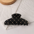 Glossy black acrylic hair claw clip with golden studs and quilted pattern design - Black