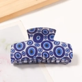 Rectangular hair claw clip with dark blue evil eye pattern in glossy acetate finish - White Base Dark Blue Evil Eye