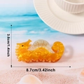 Pince à cheveux hippocampe en résine marbrée orange, dimensions 8,7 cm par 3,6 cm - Hippocampe