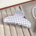 Elegant white hair claw clip with black polka dots on a soft velvet display tray - White Polka Dot