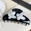 Elegant black acetate hair claw clip with white pearl butterfly and pink rhinestone accents - Butterfly Style