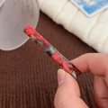 Rectangle acetate hair clip with red and blue marble pattern on a cozy background - Small Green And Red