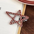 Star-shaped hair clip with brown and white polka dot pattern on a wooden table - Coffee Polka Dot Side Clip