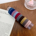 Set de 20 gomas de pelo gruesas y elásticas en colores variados sobre un cilindro - Estilo C-Colores Morandi