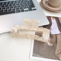 Large marbled cream white acetate shark hair claw clip in a minimalist workspace setting - Milk Coffee 13cm