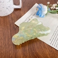 Iridescent light green cloud shark clip with pearlescent finish on wooden desk - Green Cloud