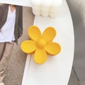 Matte bright yellow flower hair claw clip displayed on a minimalist white desk setting - Lemon Yellow / 7.5cm