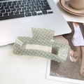 Large 13cm checkerboard shark hair clip in grey-green and cream on a desk - Yellow Blue Checkerboard 13cm