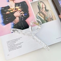 Clear acrylic jumbo hair claw clip with gold spring shown on fashion magazine - Clear