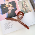 Large amber brown translucent hair claw clip with cross design on fashion magazine - Brown