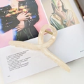 Extra large 13cm cream jelly hair claw clip with cross twist design on a magazine - Beige