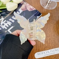 Iridescent butterfly hair claw clip with pearlescent finish held in hand - Yellow Butterfly