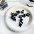 Matte black mini rabbit ear hair claws set for children shown on a white ceramic plate - Black Mixed Colors