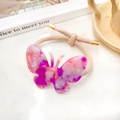 Élastique à cheveux avec papillon en acétate marbré rose et violet et détails dorés - Rose rouge