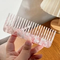Pink marble pattern acetate wide-tooth hair comb held against a cozy indoor background - 13cm / Floral Pink