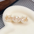 Three cream marble cat hair clips with golden facial expressions on a display tray - Off-white 6.5CM