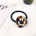 Elastic tortoise shell hair tie with a yellow smiley face charm on a pink background - Leopard Print 3.5CM