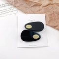Elegant set of two black acetate teardrop hair clips with gold oval logo detailing - 4cm / Black