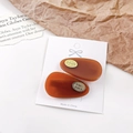 Set of two amber brown resin teardrop hair clips with gold logo on a white display card - 4cm / Chocolate