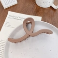 Deep brown matte hair claw clip with cross twist design on a minimalist ceramic plate - Wave Coffee 13CM