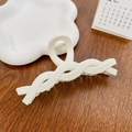 Elegant milky white hollowed hair claw clip with woven design on wooden background - Twist White 12cm