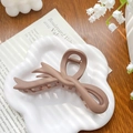 Haarklammer in Mattbraun mit Schmetterlings-Design auf einem stilvollen Tablett - Band Kaffee 12cm
