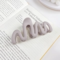 Matte light purple wave shaped hair claw clip on a French book background - Milky Coffee 10.5CM