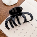 Glossy black large shark hair claw clip for thick hair styling on a wooden table - Glossy Black 10CM