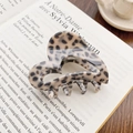 Elegant heart-shaped tortoiseshell hair claw clip with leopard pattern on vintage books - Milk Tea Coffee