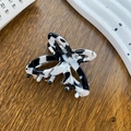 Elegant black and white marble acetate hair claw clip for women on a wooden background - Cow Pattern