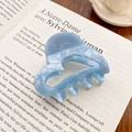 Light blue acetate heart hair claw clip with marble texture on vintage book pages - Sapphire Blue
