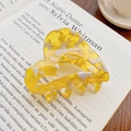 Yellow and white marble heart claw clip made of acetate on a French book page - Pineapple Yellow